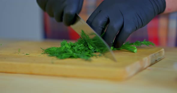 Dill Cut with a Knife on a Wooden Board Closeup