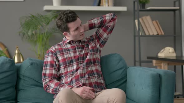 Man Having Neck Pain While Sitting on Sofa