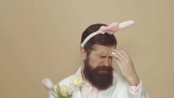 Photo of Funny Guy Enjoy Easter Party Hold Tulips Bouquet Flowers Wear Bunny Ears.