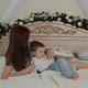A Young Mother and Her Son Lying on the Bed - VideoHive Item for Sale