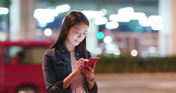 Woman Use of Mobile Phone in City at Night