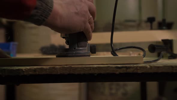 A Furniture Factory Worker Processes a Block of Wood for a Set of Products