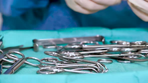 Scrub Nurse Preparing Surgical Instruments for Operation.