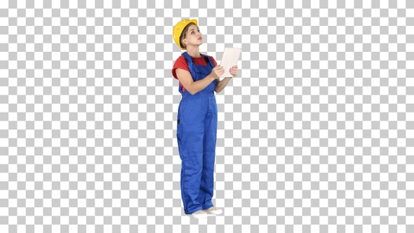 Female Engineer in Yellow Safety Helmet Is Looking to Tablet 