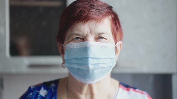 Elderly Woman in Mask Looking at Camera