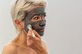 Middle aged female with clay mask - PhotoDune Item for Sale