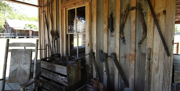 Antique Farms Tools Hanging Under Poarch
