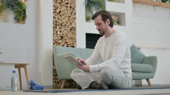 Young Man Using Tablet While Standing in Kitchen