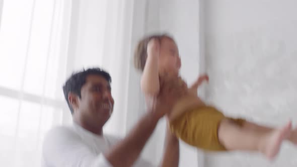 Father Lifting Happy Toddler Girl