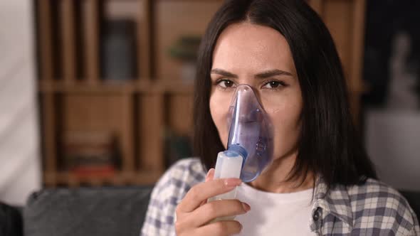 Sick Caucasian Woman with an Inhaler