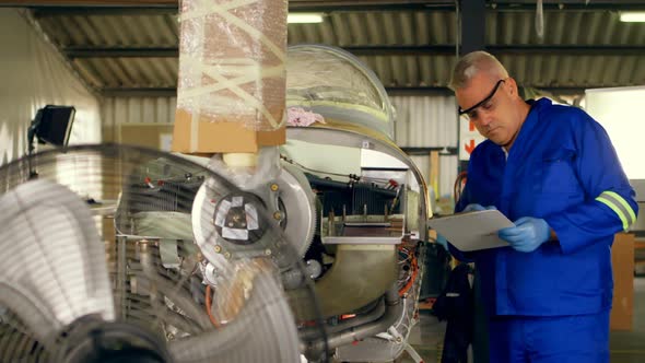 Engineer checking an aircraft in hangar 4k