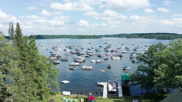 Aerial, boats crowded on a lake during spring summer break