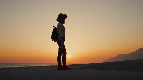 Young photographer with a retro camera on the beach