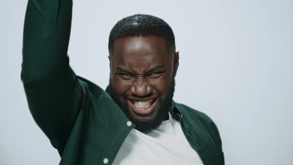 Portrait of Smiling African Man Showing Yes Gesture on Grey Background