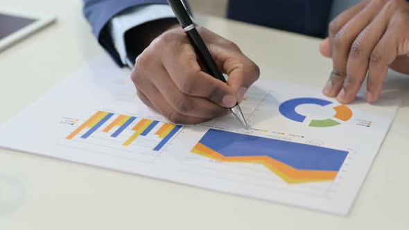 African Businessman Working on Documents Close Up