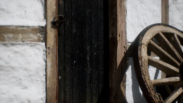 Old Wood Wheel and Black Door at White House alt