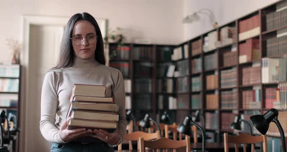 Girl Holding Books Stack in Hands