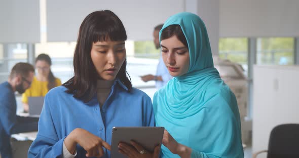 Young Business Colleagues Working on Tablet in Modern Office