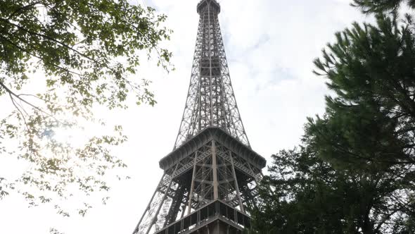 Tilting on  Tour Eiffel  in front of clouds by the day Paris France 4K 2160p 30fps UltraHD  footage 