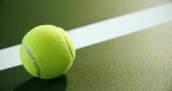 Close-up of tennis ball near white line