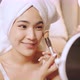 Happy attractive asian woman apply skincare cream on face and body - VideoHive Item for Sale