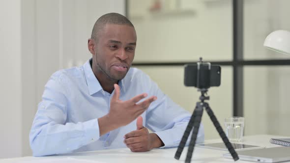 Talking African Man Blogging Smartphone Work