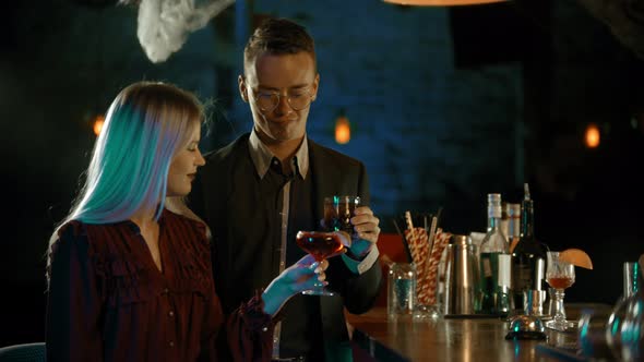 A Couple Talking By the Stand in the Bar - Tasting the Cocktails