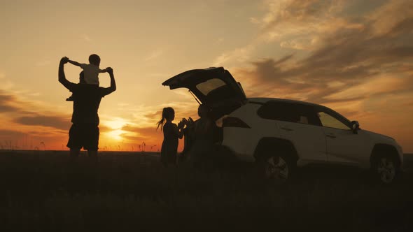 Silhouette the Happy Family of Four People, Mother, Father and Two Children Are Happy Sitting in the