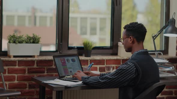 Financial Consultant Using Laptop to Work on Business Growth