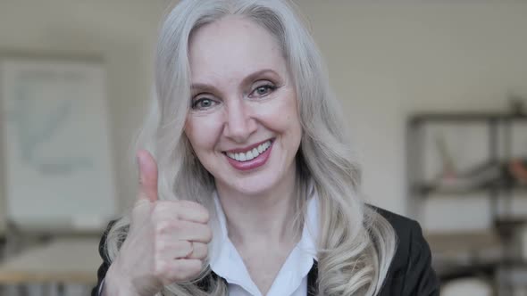 Thumbs Up By Middle Aged Businesswoman