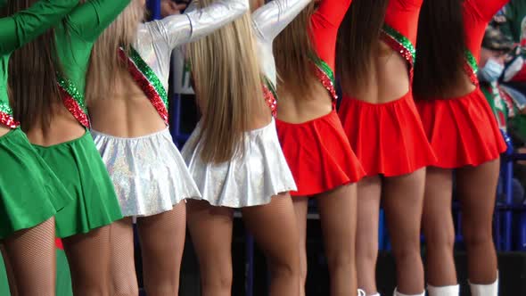 Women in Short Dresses Dance Supporting Players at Stadium