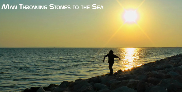 Man Throwing Stones Into The Sea