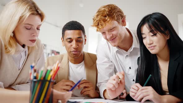 Close Up Portrait of Multiethnic Young Colleagues Group Discussing New Marketing Strategy at Office