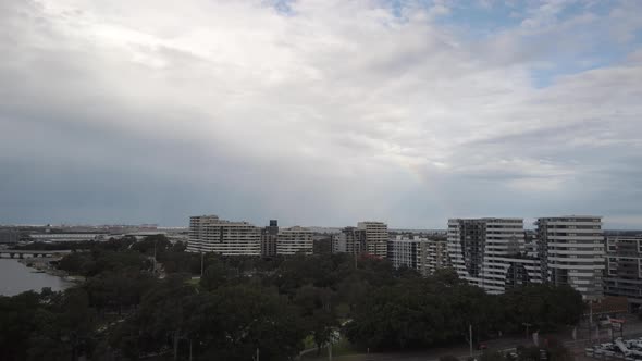 Panning shot of rainbow after the rain at Sydney Airport sky in a cloudy day