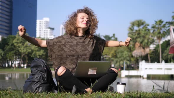 Happy Woman Working On Laptop In Park