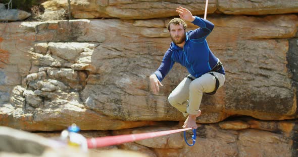 Mountaineer trying to get balance on the rope