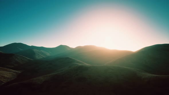 Hills with Rocks at Sunset