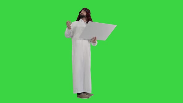 Sheikh Looking at Blueprint with Project of a Building Next To Him on a Green Screen, Chroma Key