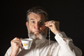 Man with muttonchops and funny expression holding monacle and cup of tea. - PhotoDune Item for Sale