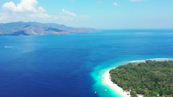 Tropical birds eye clean view of a white sand paradise beach and blue sea background in colorful
