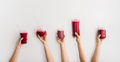 Hands holding glasses with beet and pomegranate smoothie, wide composition - PhotoDune Item for Sale