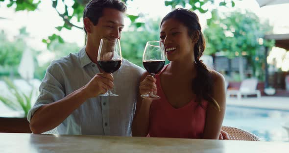 Couple Enjoying Glass of Wine at Luxury Resort