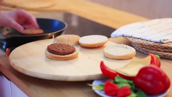 View on buns and  meat for burger in pan on background