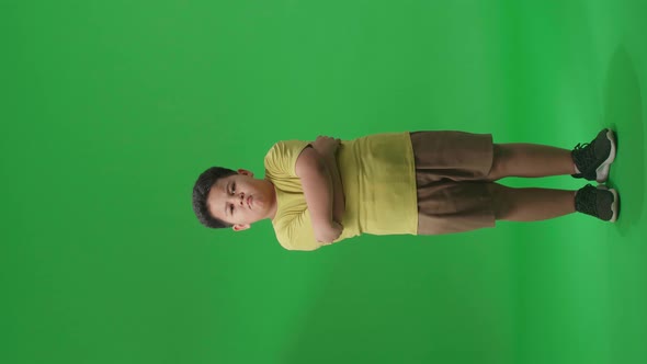 Full Body Of Asian Little Boy Posing In The Green Screen Studio