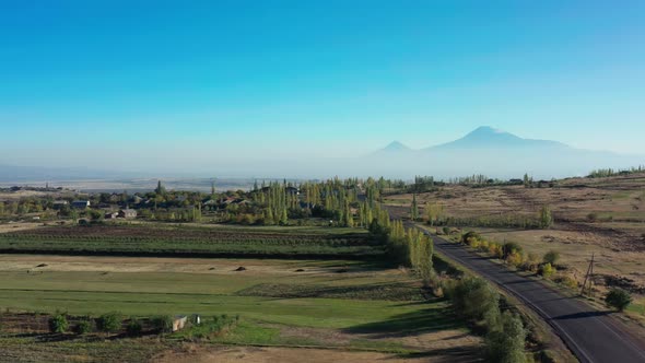 Aerial Drone Shot Pan Shot of Fields and Trees on Background of Mount Aragats