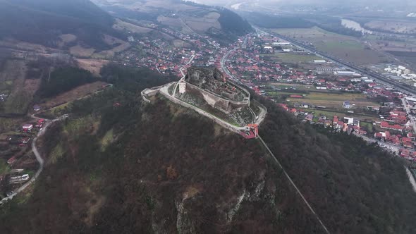 Stunning Aerial View of the Medieval Stone Fortress of Deva on a Cloudy Day