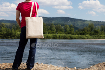 Placeit – Woman holding eco bag mockup, river view / Photodune, Misc