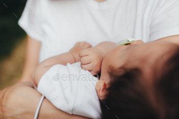 Little baby's hands, mother with baby, care of baby, mother carrying baby