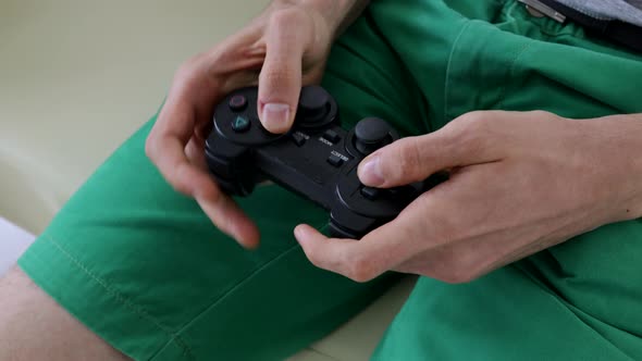Close view of a gamer's hands playing a game
