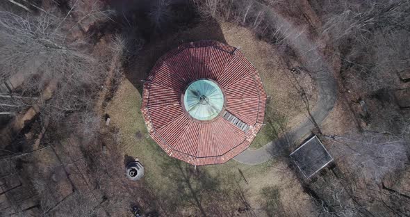 Moving Up Away Overhead Above Building or Church in Middle of Bare Woods Forest in Autumn or Winter